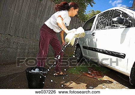 Young woman cleaning her car. View Large Photo Image Stock Photograph - Young woman cleaning her car.. Fotosearch