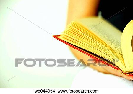 Picture - 19 years old girl reading old red book.. Fotosearch