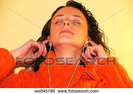 20 -30 year old woman listening music on a MP3 player View Large Photo Image Stock Photo - 20 -30 year old woman listening music on a MP3 player. Fotosearch