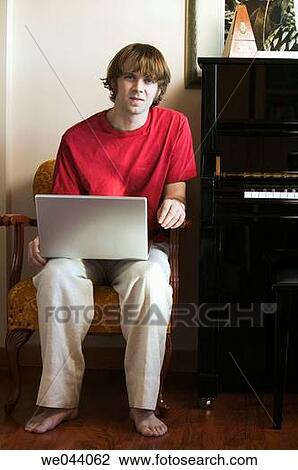 Stock Image - 30's, barefoot, at-home, 20's. Fotosearch