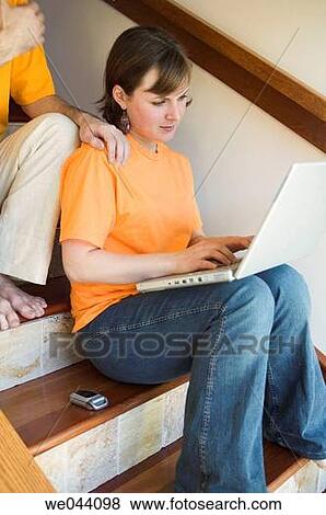 Stock Photo - 30's, barefoot, at-home, 20's. Fotosearch