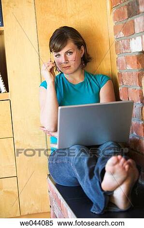 Stock Photography - 30's, barefoot, at-home, 20's. Fotosearch