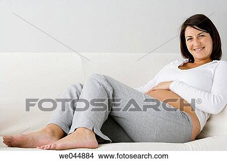 Picture - 30's, belly, barefoot, at-home, 20's. Fotosearch