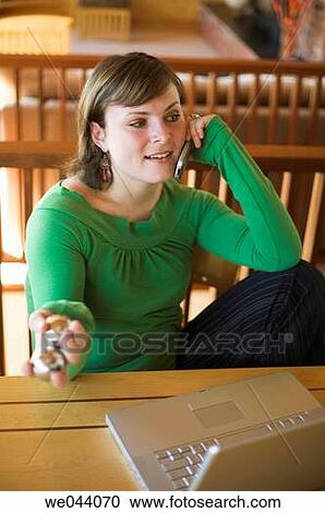 Stock Image - 30's, calling, at-home, absorbed, 20's. Fotosearch