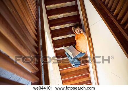 Stock Image - 30's, calling, barefoot, at-home, 20's. Fotosearch