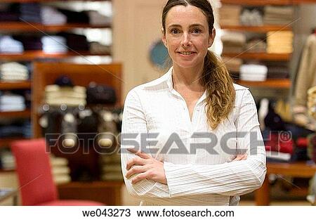 Arms crossed, Clothing store, arms folded, 30's View Large Photo Image Stock Image - Arms crossed, Clothing store, arms folded, 30's. Fotosearch