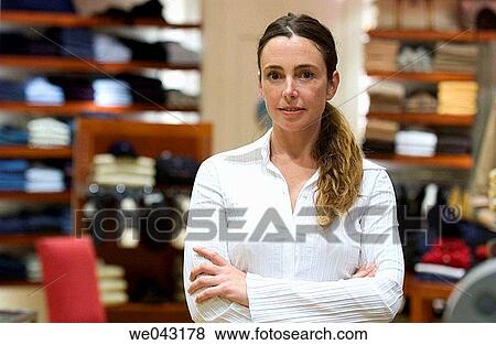 Arms crossed, Clothing store, arms folded, 30's View Large Photo Image Stock Photo - Arms crossed, Clothing store, arms folded, 30's. Fotosearch