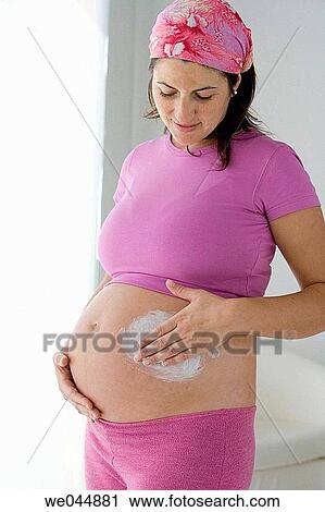 Stock Image - at-home, belly, Beauty Care, beauty, apply. Fotosearch