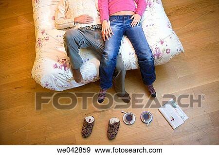 Stock Photo - barefoot, bed, bedroom, calm, coffee. Fotosearch