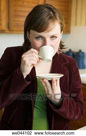 Stock Image - blue eyes, coffee, at-home. Fotosearch