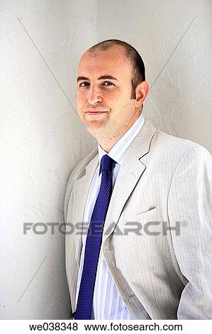 Business man in corner smiling in camera View Large Photo Image Stock Photo - Business man in corner smiling in camera. Fotosearch