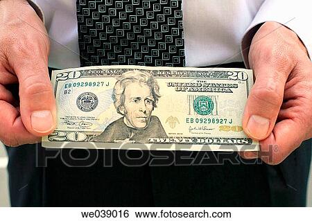 Business man presents 20 US Dollar note View Large Photo Image Stock Photograph - Business man presents 20 US Dollar note. Fotosearch