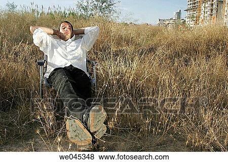 Businessman resting on lounger View Large Photo Image Stock Photo - Businessman resting on lounger. Fotosearch