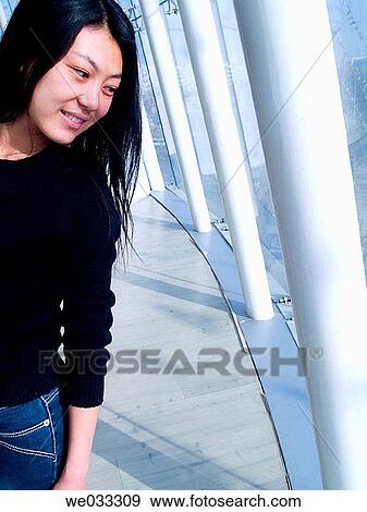 Chinese girl looking down from second floor in building. View Large Photo Image Stock Photo - Chinese girl looking down from second floor in building.. Fotosearch