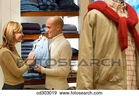 Stock Photo - choice, Clothing store, choosing, 30's. Fotosearch