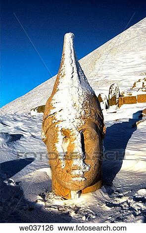 Stock Photograph - Colossal head of Antiochus, remains of the tomb-sanctuary of King Antiochus Theos in the West terrace of Nemrut Dag (Mount Nemrut, 2150 m) part of the former Commagene kingdom. Anatolia, Turkey. Fotosearch