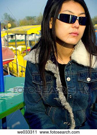 Cool Chinese girl sunglasses seated on the docks. View Large Photo Image Stock Image - Cool Chinese girl sunglasses seated on the docks.. Fotosearch