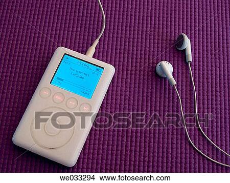 iPod showing song title on purple background. View Large Photo Image Picture - iPod showing song title on purple background.. Fotosearch