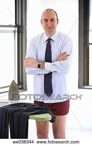 Man ironing clothing in his underwear in apartment View Large Photo Image Picture - Man ironing clothing in his underwear in apartment. Fotosearch