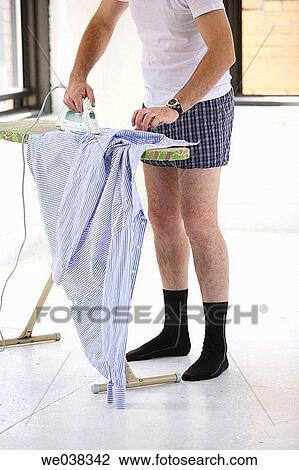 Man ironing clothing in his underwear in apartment View Large Photo Image Stock Image - Man ironing clothing in his underwear in apartment. Fotosearch
