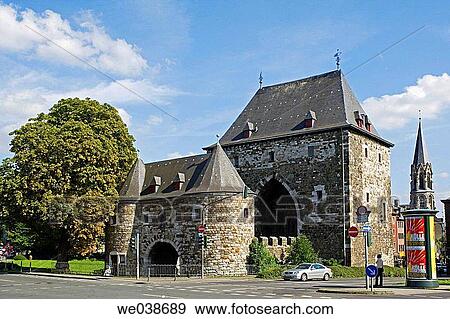 Stock Photo - Ponttor with Heilig-Kreuz-Church. Pont Gate was part of the historical city fortifications and was built around the 1300th. Aachen. North Rhine-Westphalia. Germany. Fotosearch
