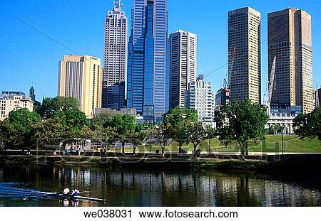 Stock Image - Rowers on Yarra river with Melbourne Central Business District. Victoria. Australia.. Fotosearch