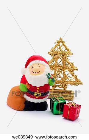 Santa figurine and Christmas tree with dropout background View Large Photo Image Stock Photo - Santa figurine and Christmas tree with dropout background. Fotosearch