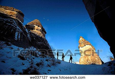 Stock Photo - Silhouettes of people between fairy chimneys, Pasabagi, Devrent Valley, Zelve. Cappadocia, Turkey. Fotosearch