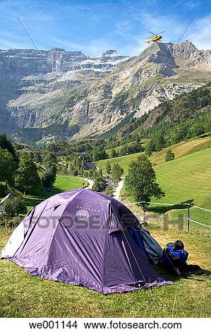 Tent under the Cirque de Gavarnie. Helicopter flying over Parc National des Pyr? n? es. Francia. View Large Photo Image Picture - Tent under the Cirque de Gavarnie. Helicopter flying over Parc National des Pyr? n? es. Francia.. Fotosearch