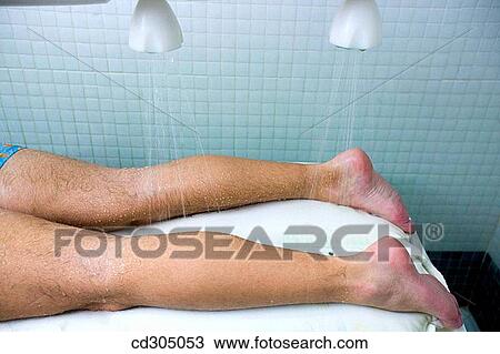 Stock Image - Vichy Shower. Relaxing sea water shower to ease muscle tension. Fotosearch