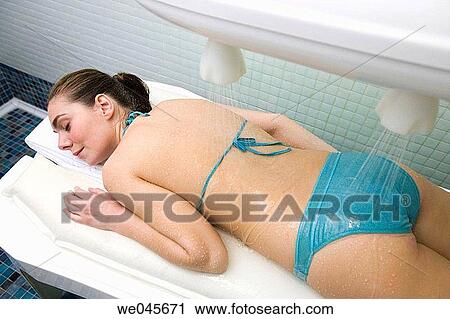 Stock Image - Vichy Shower. Relaxing sea water shower to ease muscle tension. Fotosearch