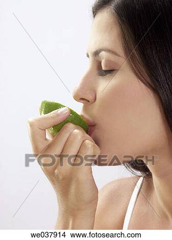 White background. Woman tasting fruit. Woman tasting lemon View Large Photo Image Picture - White background. Woman tasting fruit. Woman tasting lemon. Fotosearch