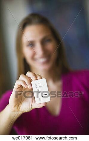 Woman holding pregnancy test View Large Photo Image Stock Image - Woman holding pregnancy test. Fotosearch