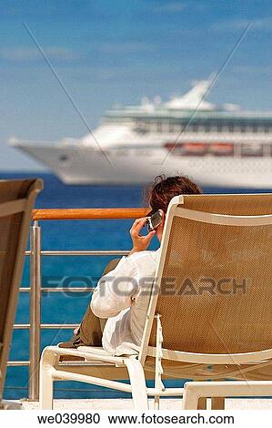 Woman with a cell phone on a deck, Cozumel, Mexico View Large Photo Image Stock Image - Woman with a cell phone on a deck, Cozumel, Mexico. Fotosearch