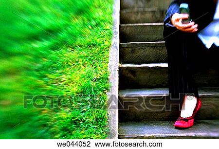 young business woman sitting on stairs using cell phone View Large Photo Image Stock Image - young business woman sitting on stairs using cell phone. Fotosearch