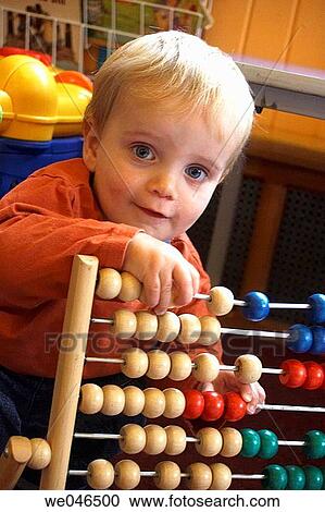 1 year old boy looking at an abacus View Large Photo Image Stock Image - 1 year old boy looking at an abacus. Fotosearch