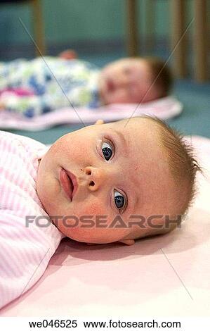 2 month old baby girl lying on her back, with big blue eyes View Large Photo Image Stock Photography - 2 month old baby girl lying on her back, with big blue eyes. Fotosearch