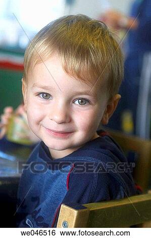 Stock Photograph - 3 year old boy at nursery smiling into camera.. Fotosearch