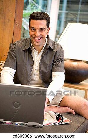Stock Photography - 30's, barefoot, at-home, 20's. Fotosearch