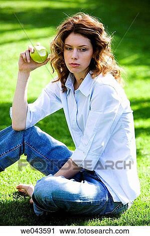 Stock Image - absorbed, barefoot, apple, 20's. Fotosearch