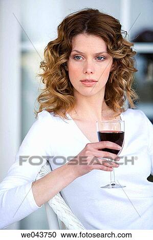 Stock Image - absorbed, blue eyes, Alcoholic drink, alcohol, 20's. Fotosearch