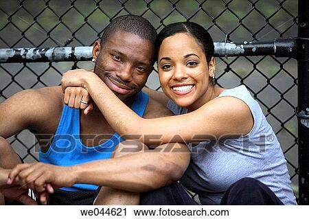 Stock Image - African-American couple smiling into the camera. Fotosearch