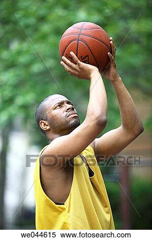 African-American man shooting a basketball View Large Photo Image Stock Photography - African-American man shooting a basketball. Fotosearch