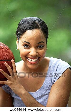African-American woman with basketball smiling into camera View Large Photo Image Picture - African-American woman with basketball smiling into camera. Fotosearch