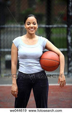 African-American woman with basketball smiling into camera View Large Photo Image Stock Photo - African-American woman with basketball smiling into camera. Fotosearch