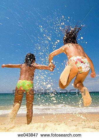 Stock Photo - amusement, child, beach, back view, action. Fotosearch