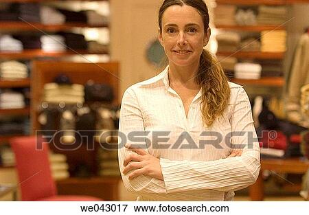 Arms crossed, Clothing store, arms folded, 30's View Large Photo Image Stock Photo - Arms crossed, Clothing store, arms folded, 30's. Fotosearch