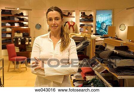 Arms crossed, Clothing store, arms folded, 30's View Large Photo Image Stock Photograph - Arms crossed, Clothing store, arms folded, 30's. Fotosearch