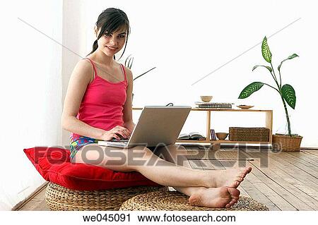 Stock Image - at-home, brunette, barefoot, 20's. Fotosearch