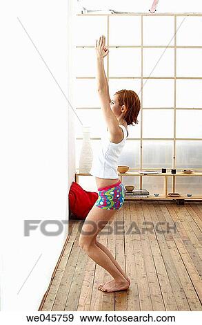 at-home, calisthenics, barefoot, Arms raised View Large Photo Image Stock Photo - at-home, calisthenics, barefoot, Arms raised. Fotosearch